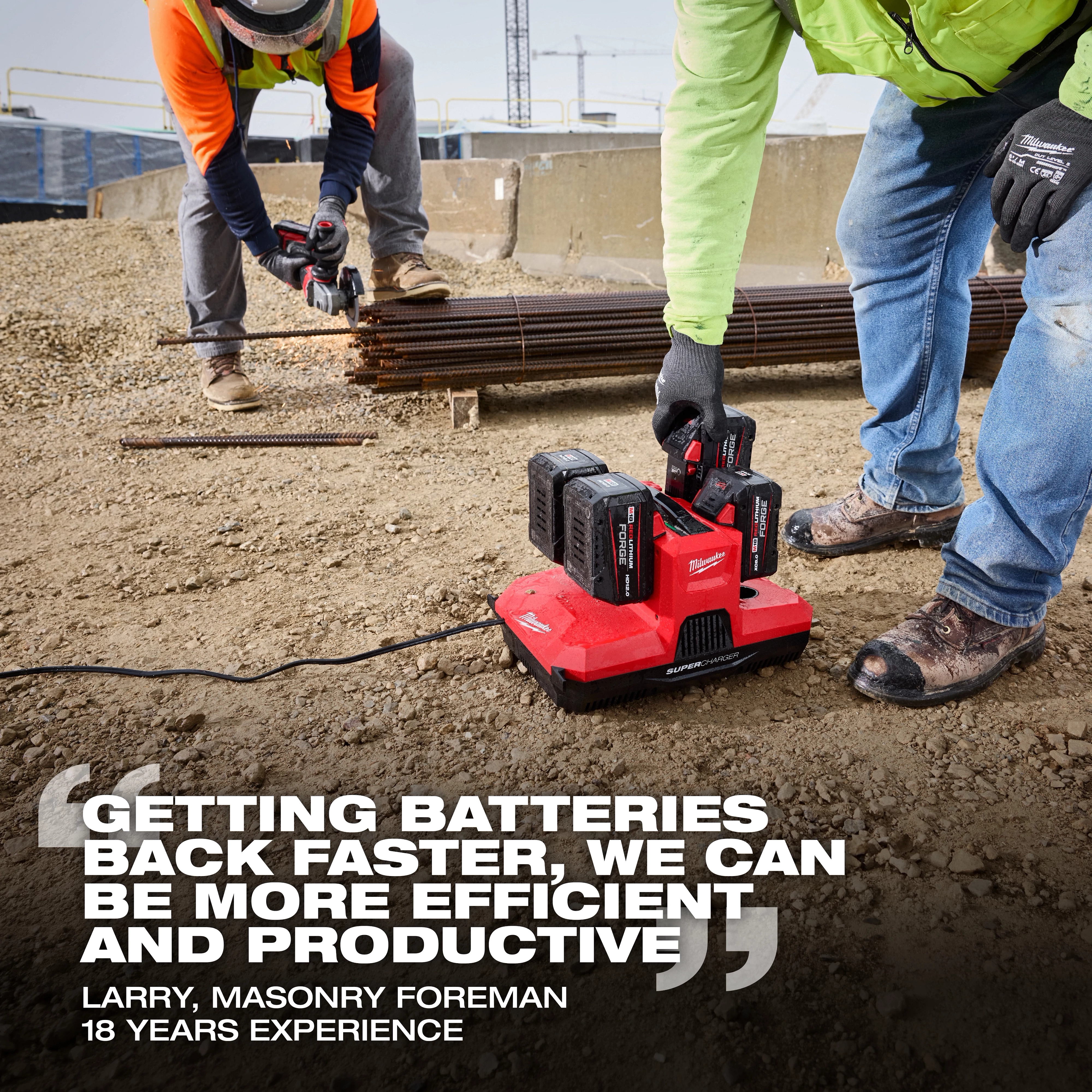 Workers on a construction site using the M18 & M12 Four Bay Simultaneous Super Charger w/ PACKOUT Compatibility.