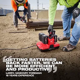 Workers on a construction site using the M18 & M12 Four Bay Simultaneous Super Charger w/ PACKOUT Compatibility.