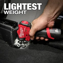 A person uses the Milwaukee M12 FUEL™ 1/4" Subcompact Impact Wrench w/ Friction Ring to tighten a bolt in a car interior. The text "LIGHTEST WEIGHT" is displayed above the tool.