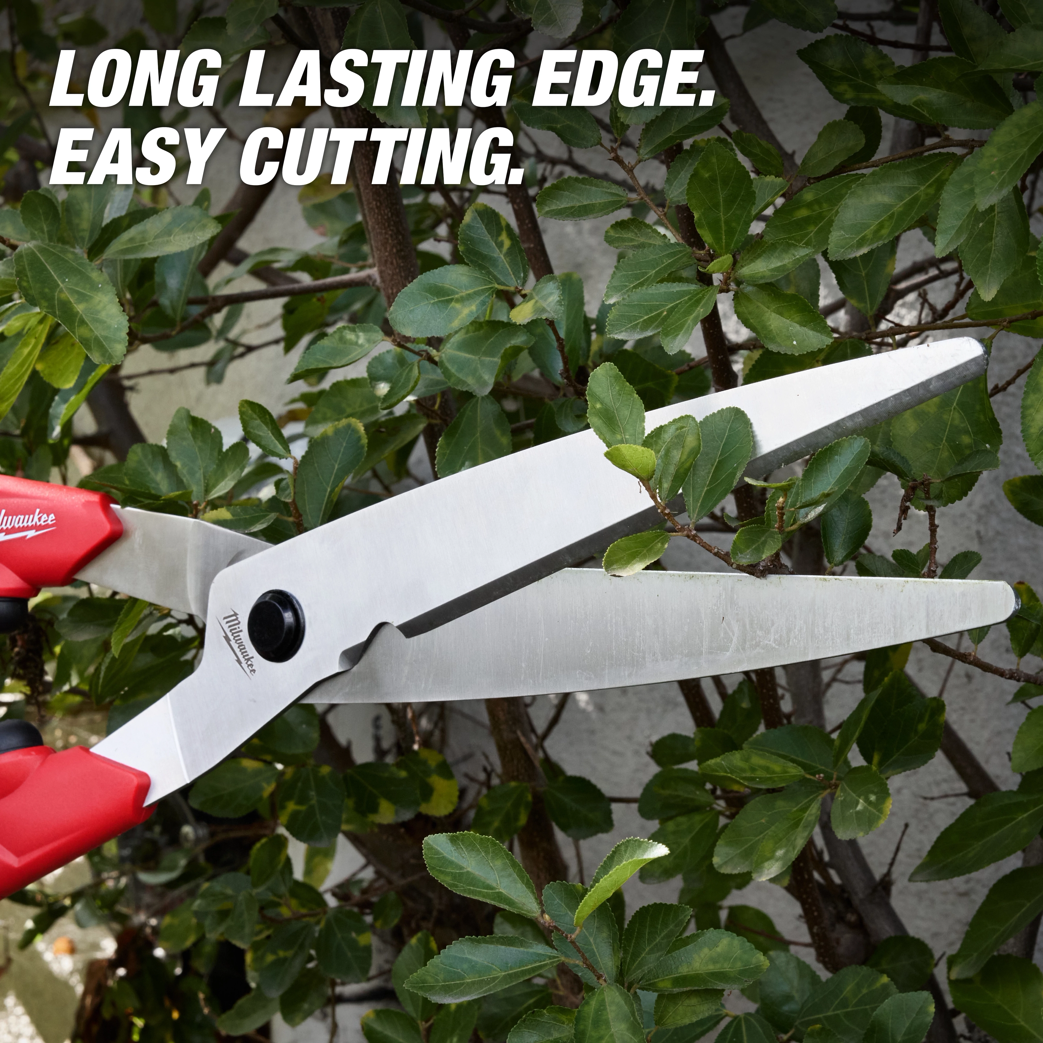 10” Hedge Shears​ with red handles cutting green hedge branches, text reads LONG LASTING EDGE. EASY CUTTING.