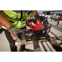 Worker holding M18 REDLITHIUM FORGE HD15 Battery Pack on M18 FUEL 9” Cut-Off Saw w/ ONE-KEY over rebar.