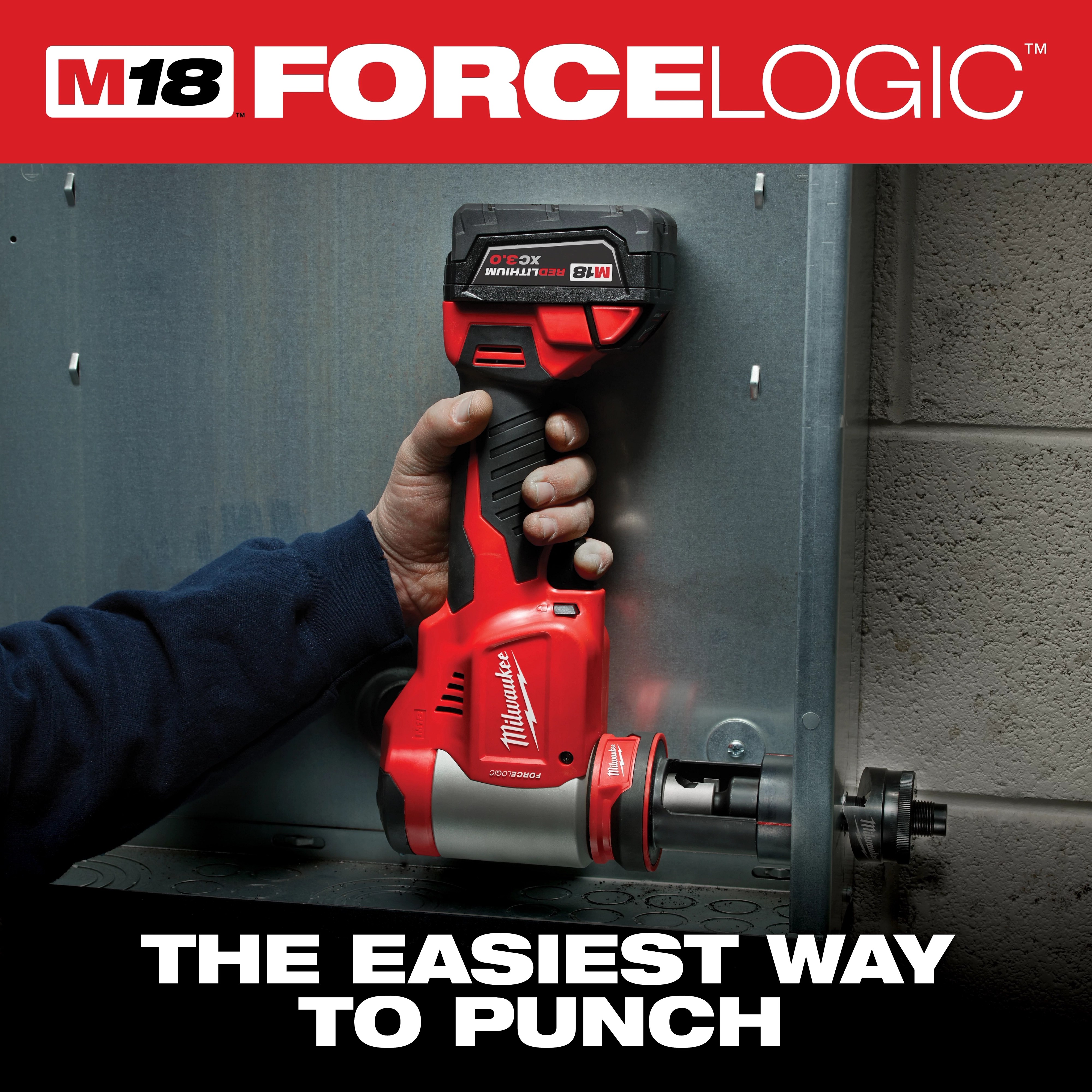 A person uses the Milwaukee M18 FORCE LOGIC cordless knockout tool to punch a hole in a metal panel. The product is shown engaged in its application, demonstrating its ease of use. The image includes the slogan "The easiest way to punch."