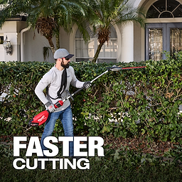 A person trims a hedge with a red electric trimmer in front of a house with palm trees. The words "FASTER CUTTING" are displayed in the bottom left corner.