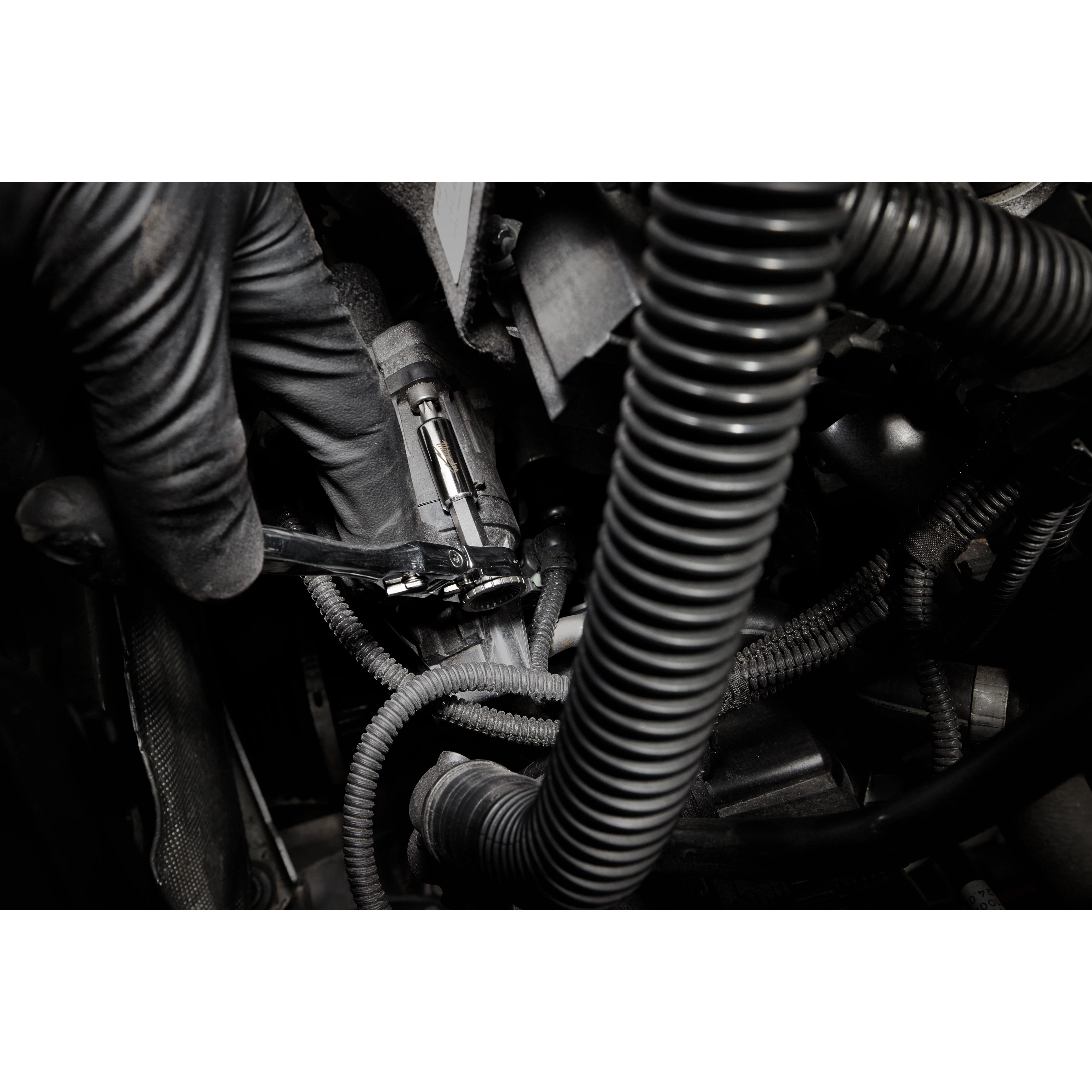 1/4” Hex Drive Mini Flex Head Bit Ratchet tightening a fastener among engine hoses and cables.