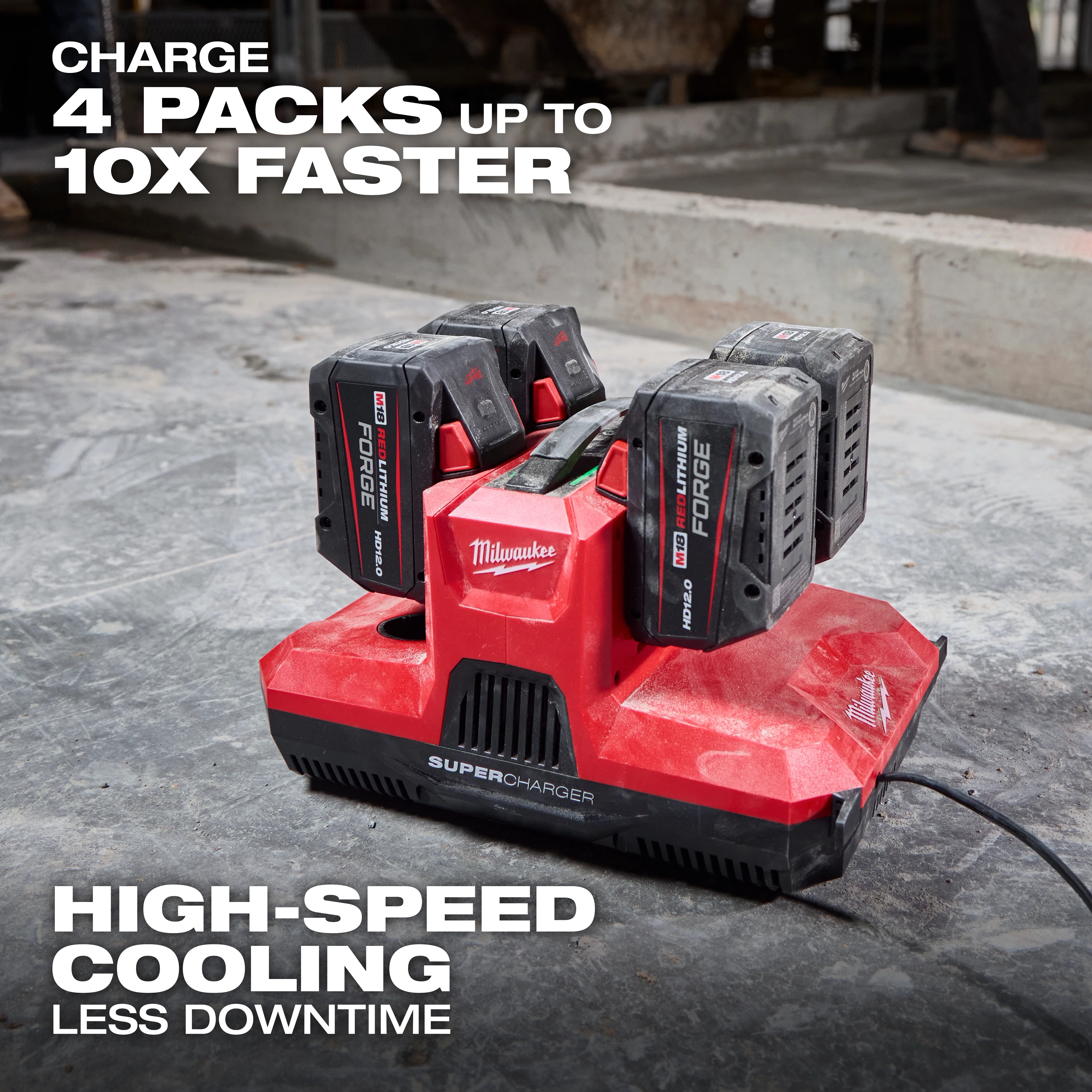 M18 & M12 Four Bay Simultaneous Super Charger w/ PACKOUT Compatibility charging four batteries on a concrete floor.