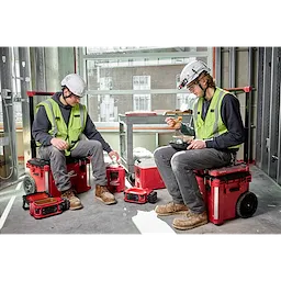 Two construction workers enjoy lunch on-site, using the M18 Jobsite Lunch Warmer.
